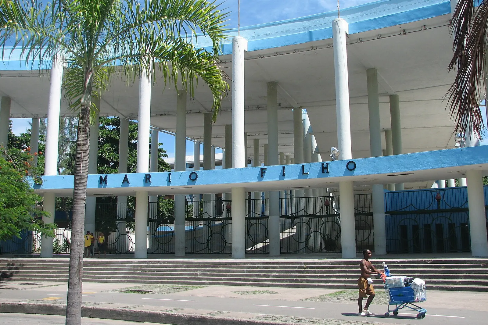The front of the Maracanã stadium, a long concrete facade of slender columns with the stadium's name in blue letters above the entrances