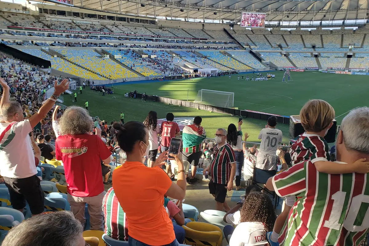 Supporters in the stands at the Maracanã, many wearing green, white and maroon striped shirts