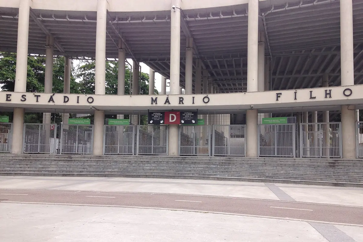 The front of the Maracanã with the stadium's formal name in large letters above the entrance columns